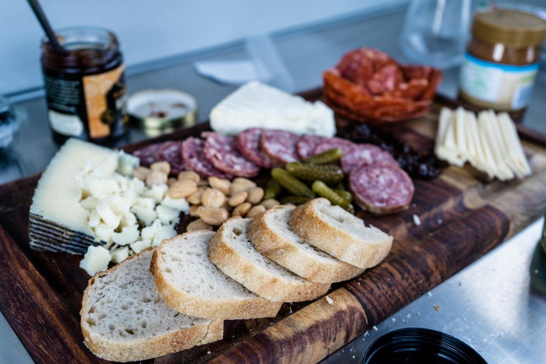 A charcuterie board prepared in the galley of a teardrop camper.