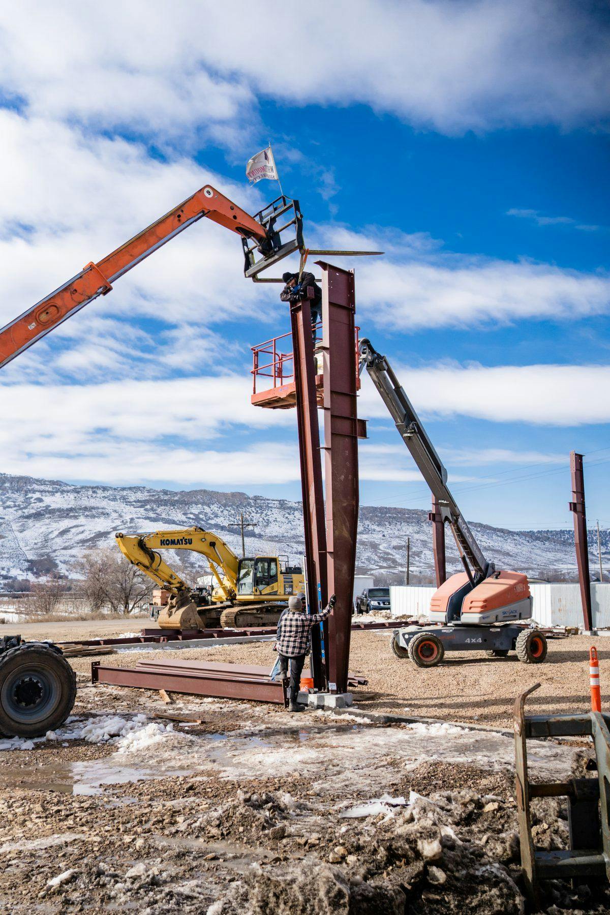 A blue sky winter day, with beams being set up to build a new manufacturing space.