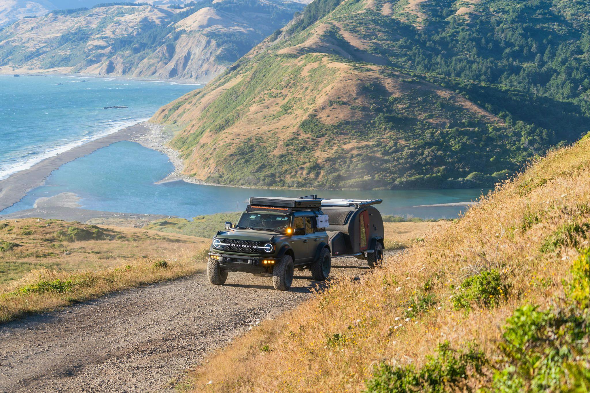 TOPO2 Voyager being towed by a Ford Bronco near the beach.