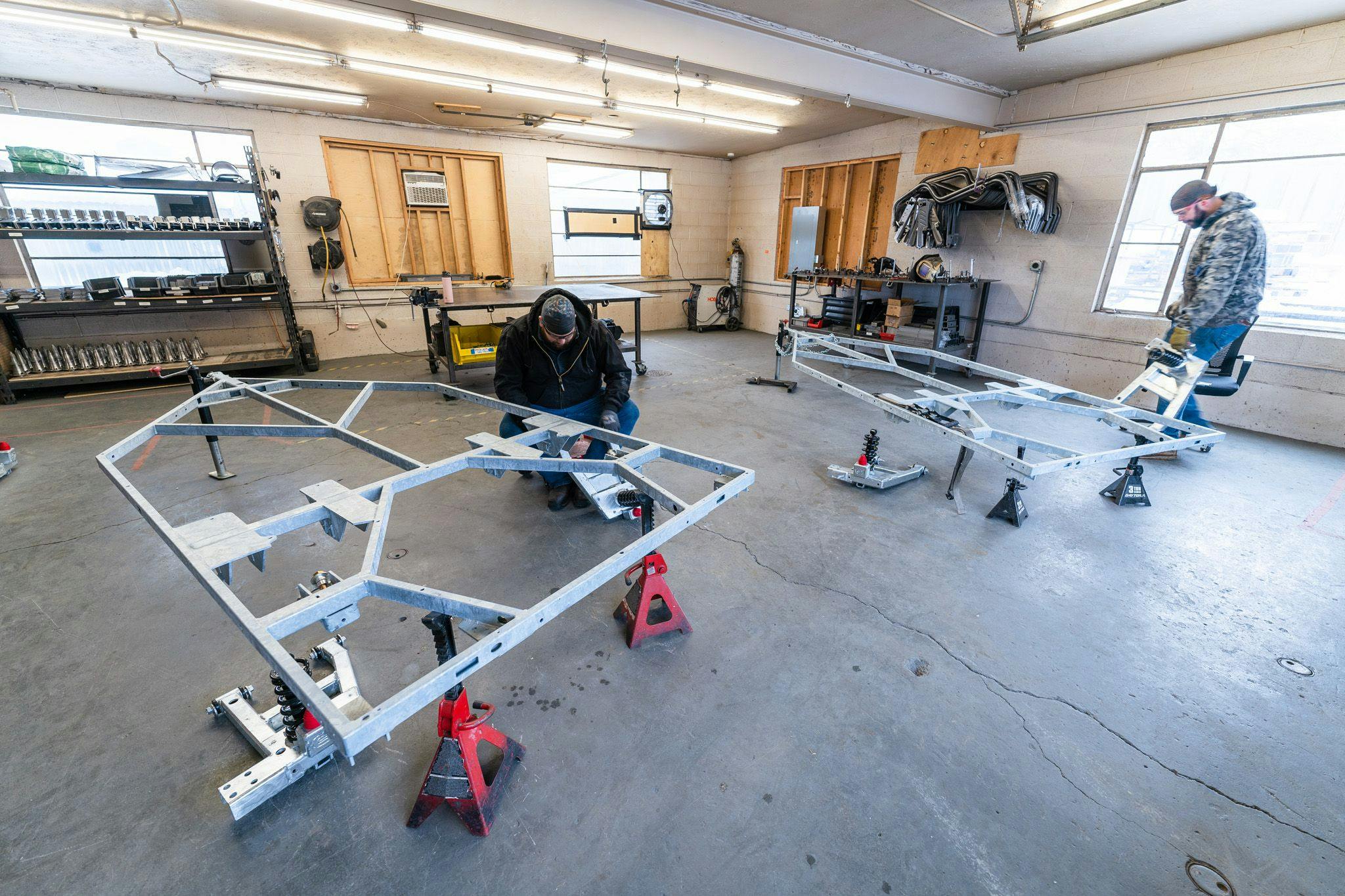 Members of the Escapod Fab Team working on welding frames for the TOPO2, an offroad trailer.