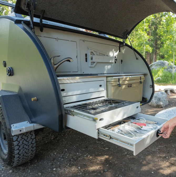 A picture displaying all the storage in the TOPO2 (a teardrop trailer) galley.