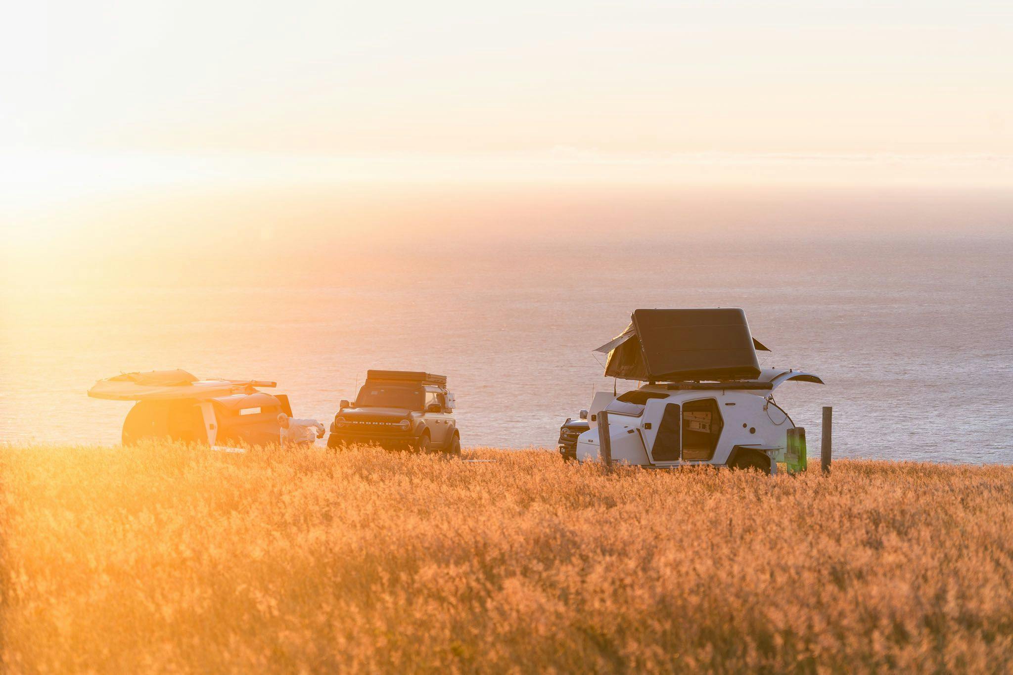 TOPO2 Voyager in a campsite overlooking the Pacific Ocean next to a Ford Bronco.