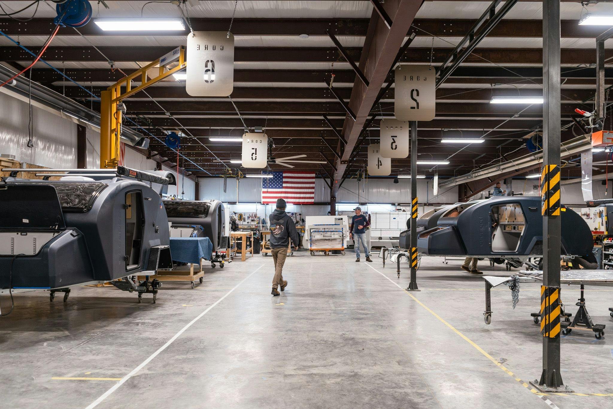 Escapod's production line, showing many TOPO2 offroad trailers in many stages of the build process.