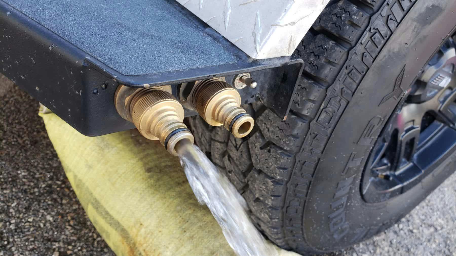 Water input and output on an Original TOPO trailer, an adventure camper.