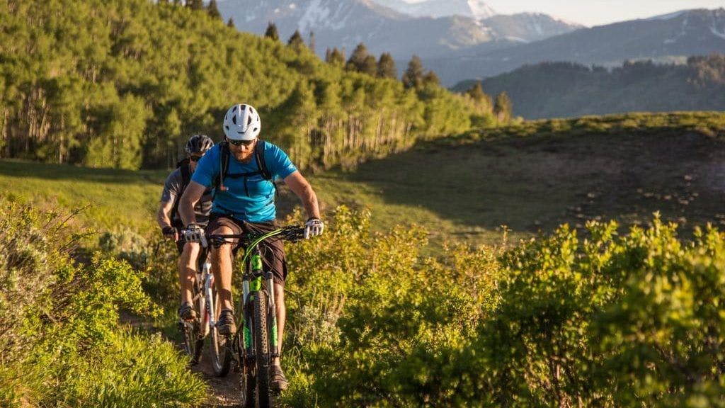 A couple riding moutain bikes at Park City Mountain Resort in Utah