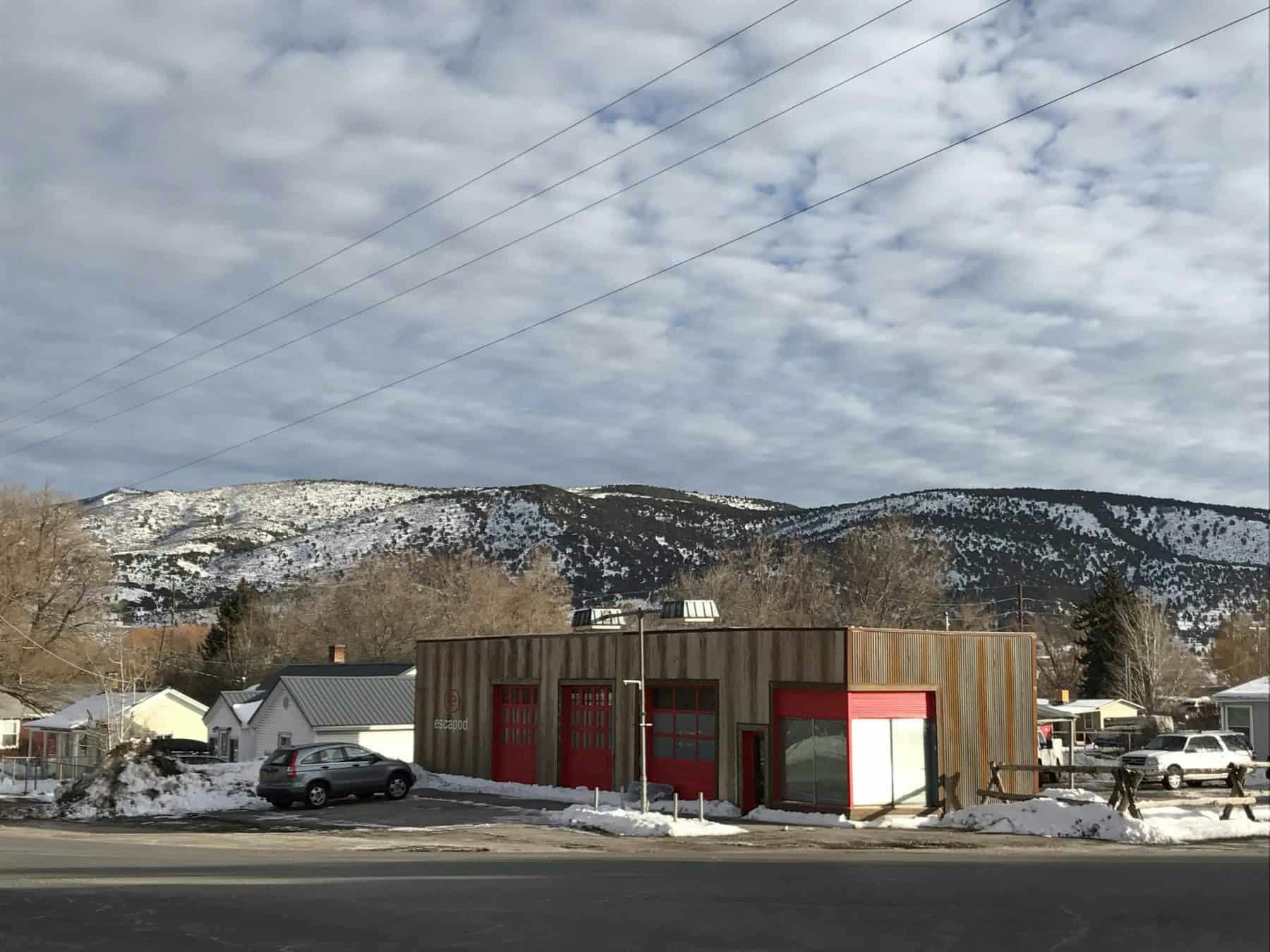 A brown and red manufacturing facility in a small rural town.