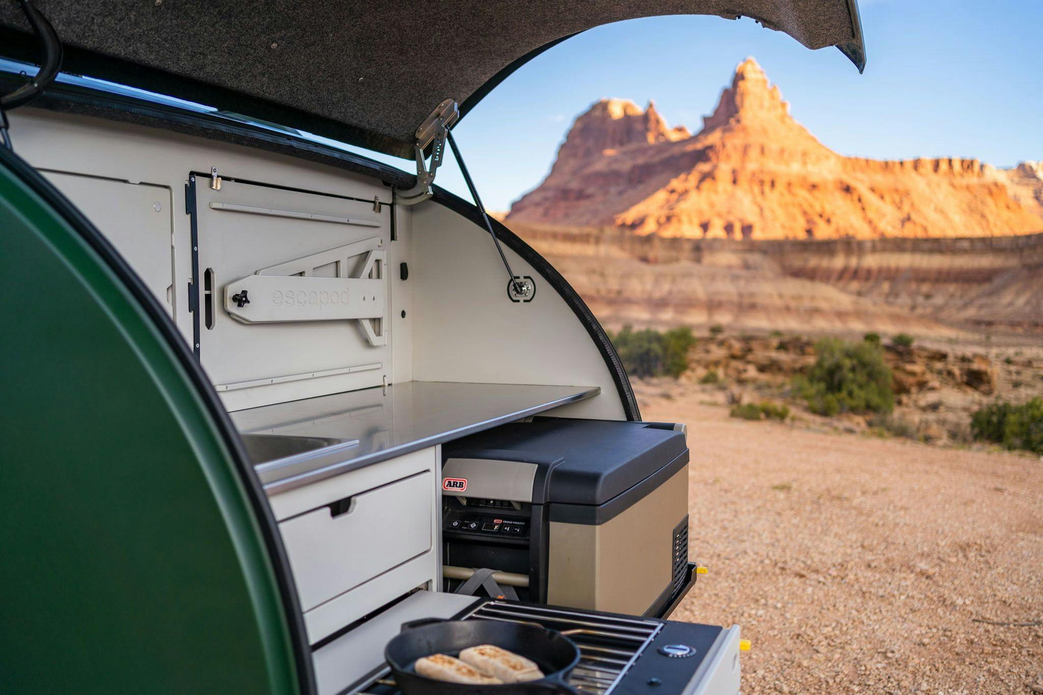 Cooking breakfast in a teardrop trailer, by Escapod Trailers.