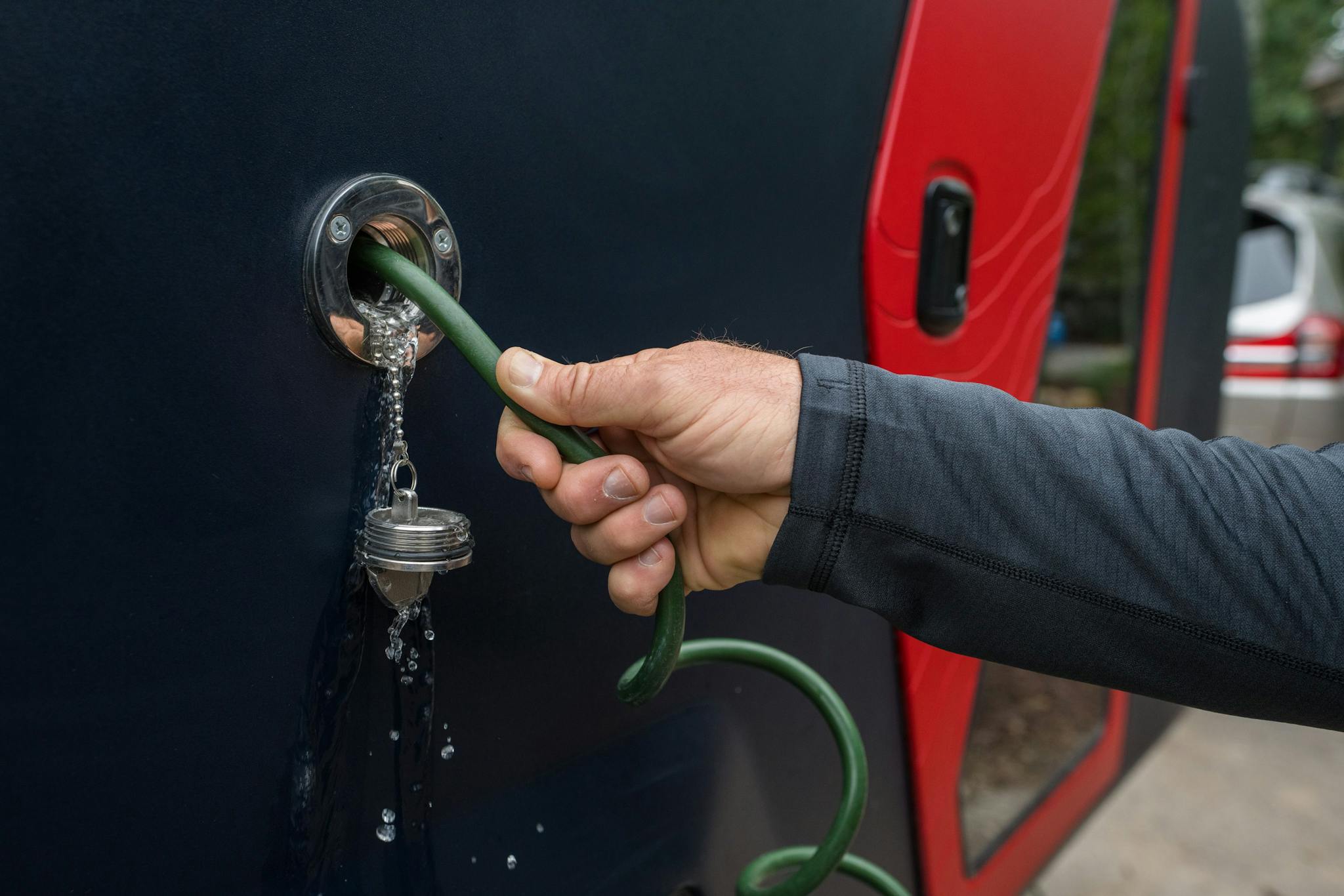 Water dripping from the gravity pour on the side of the TOPO2, an adventure trailer by Escapod Trailers.