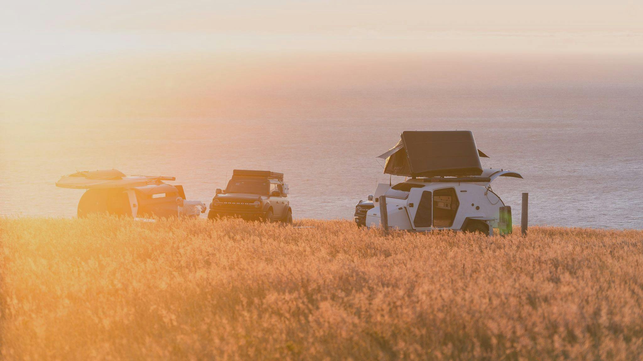 TOPO2 Voyager in a campsite overlooking the Pacific Ocean next to a Ford Bronco.