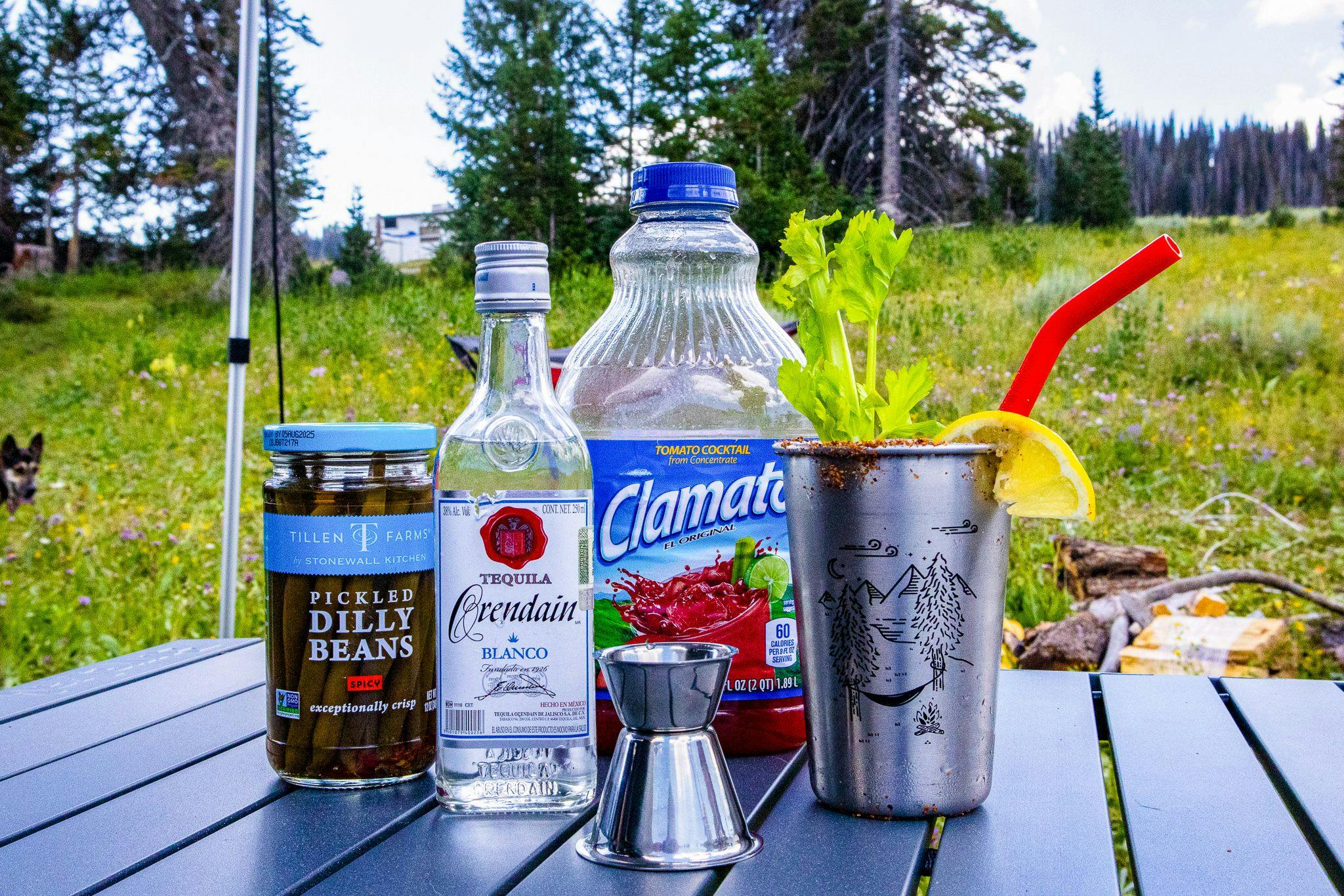 The ingredients for a Bloody Maria set up outside a teardrop camper.