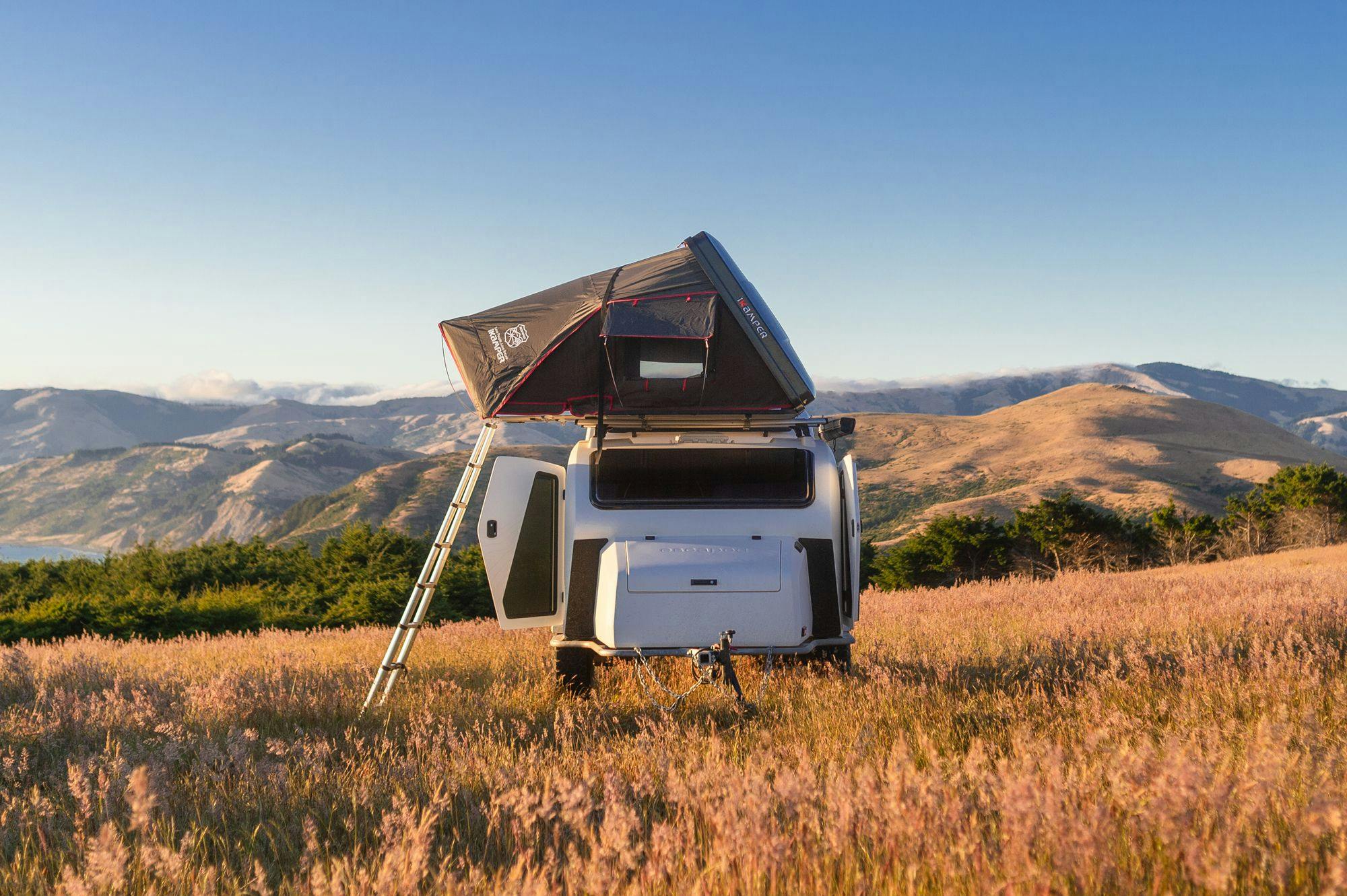 TOPO2 Voyager in a campsite overlooking the Pacific Ocean next to a Ford Bronco.