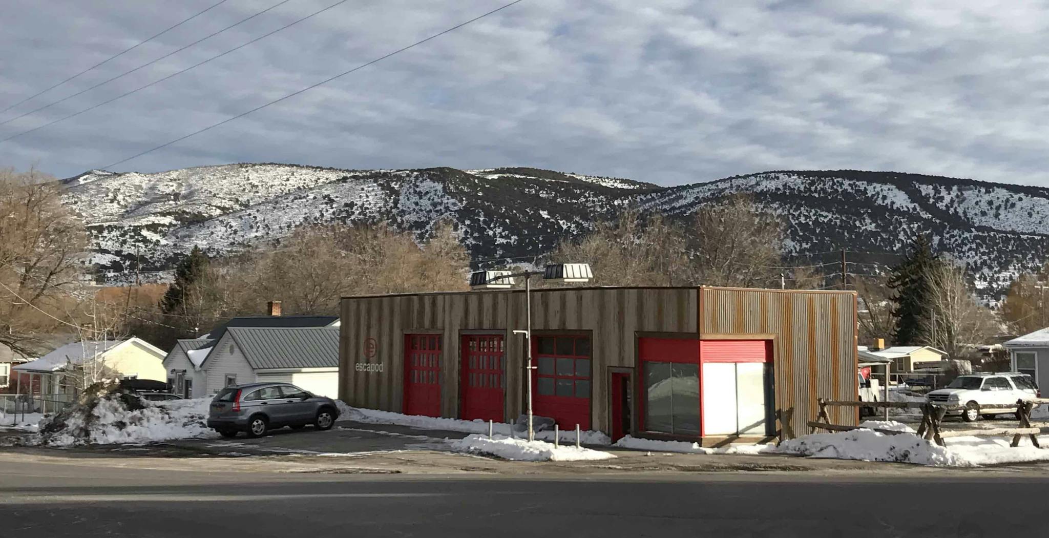 A brown and red manufacturing facility in a small rural town.