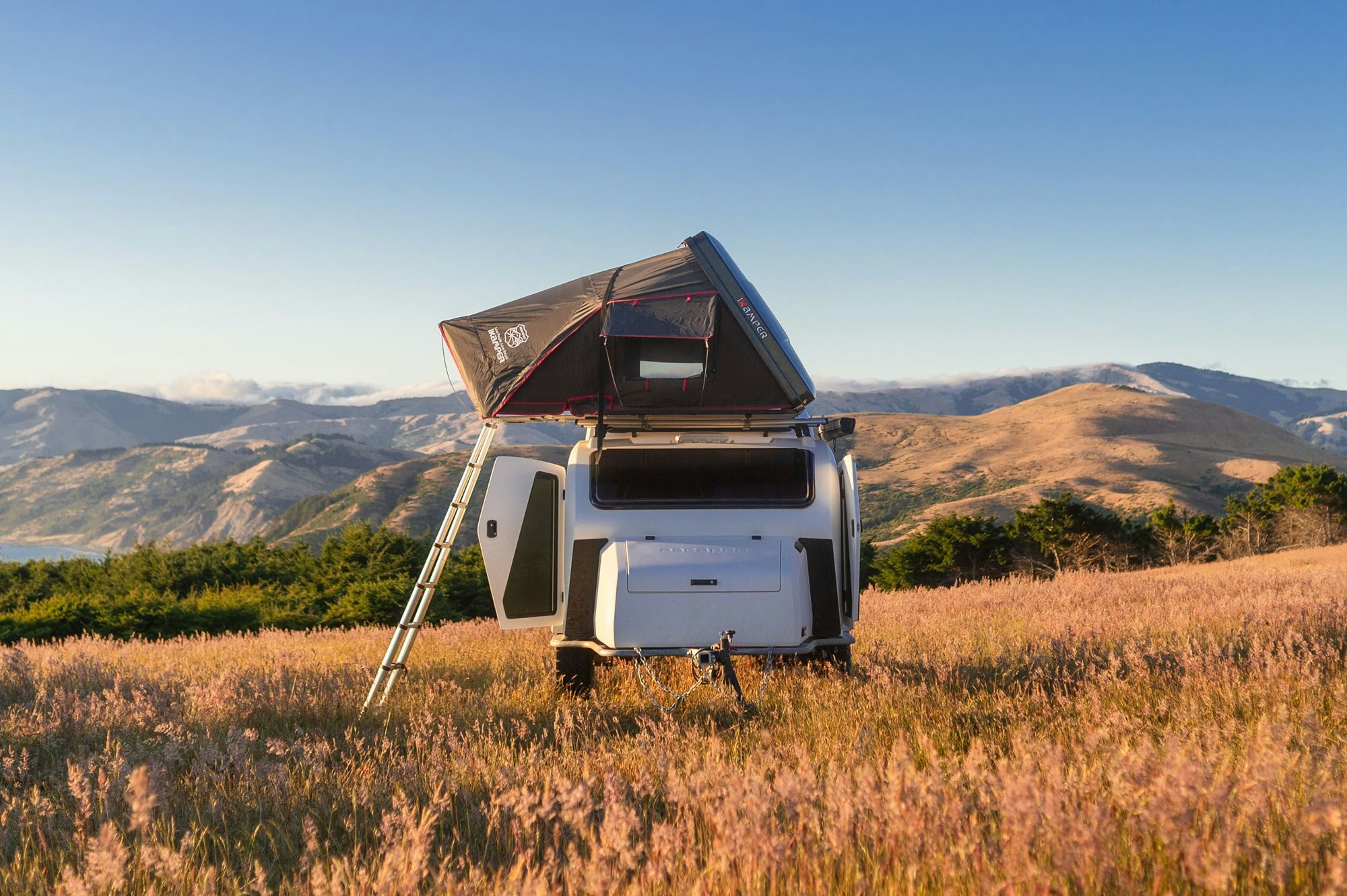 TOPO2 Voyager in a campsite overlooking the Pacific Ocean next to a Ford Bronco.